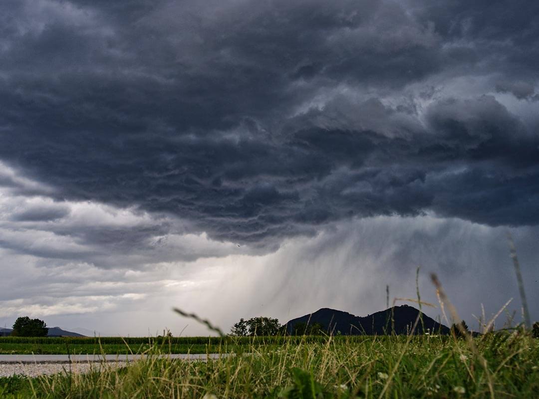 A rainstorm over meadows, representing dark days when you're going through chronic pain.